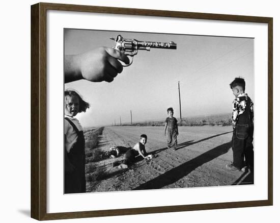 Boy's Hand Holding a Toy Six Shooter Pistol During a Game of "Cops and Robbers"-Howard Sochurek-Framed Photographic Print