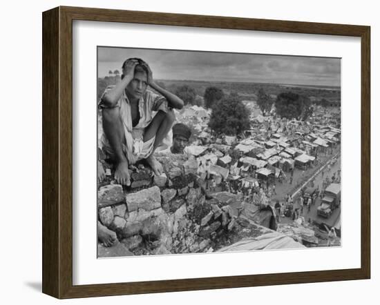 Boy Sitting on Rock Ledge Above Refugee Camp-Margaret Bourke-White-Framed Photographic Print