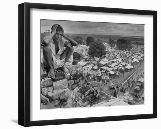 Boy Sitting on Rock Ledge Above Refugee Camp-Margaret Bourke-White-Framed Photographic Print