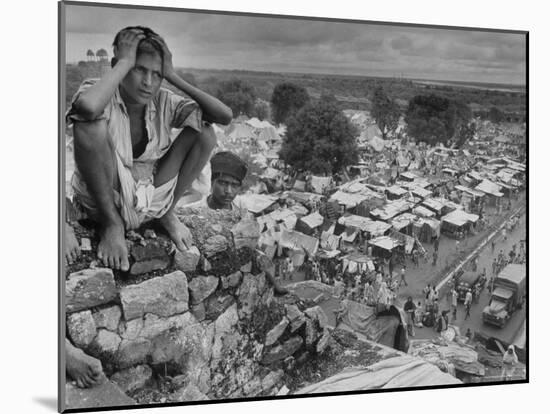 Boy Sitting on Rock Ledge Above Refugee Camp-Margaret Bourke-White-Mounted Photographic Print