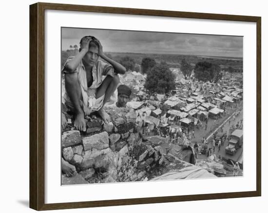 Boy Sitting on Rock Ledge Above Refugee Camp-Margaret Bourke-White-Framed Photographic Print