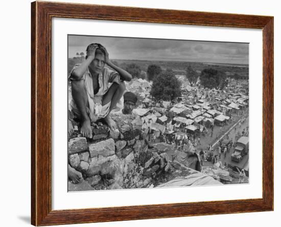 Boy Sitting on Rock Ledge Above Refugee Camp-Margaret Bourke-White-Framed Photographic Print