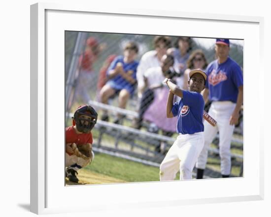 Boy Swinging a Baseball Bat on a Field-null-Framed Photographic Print