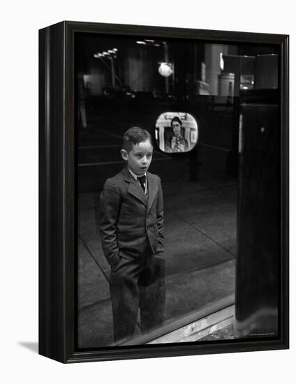 Boy Watching TV on Store Window Set, Glass Reflects the Image Off TV Screen-Ralph Morse-Framed Premier Image Canvas