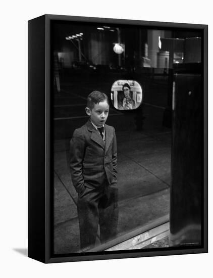 Boy Watching TV on Store Window Set, Glass Reflects the Image Off TV Screen-Ralph Morse-Framed Premier Image Canvas