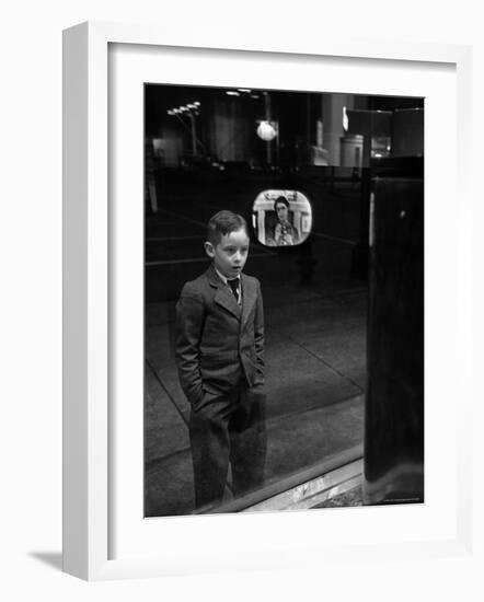 Boy Watching TV on Store Window Set, Glass Reflects the Image Off TV Screen-Ralph Morse-Framed Photographic Print