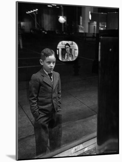 Boy Watching TV on Store Window Set, Glass Reflects the Image Off TV Screen-Ralph Morse-Mounted Photographic Print