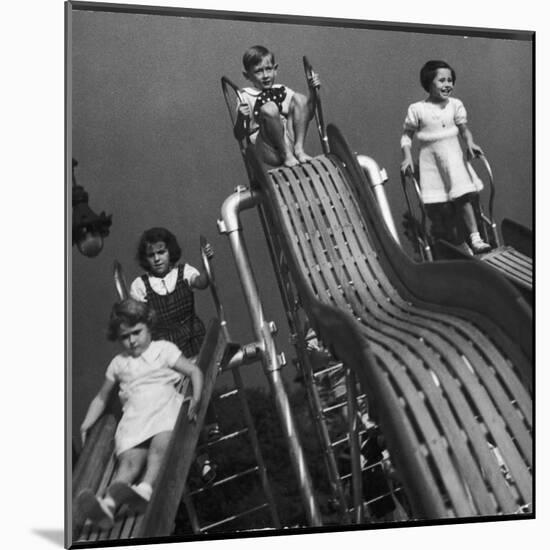 Boys and Girls Play on the Slides at a Playground-null-Mounted Photographic Print