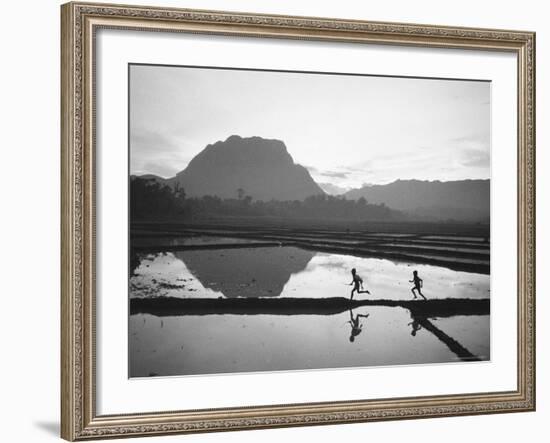 Boys Running Through Flooded Rice Paddy-John Dominis-Framed Photographic Print