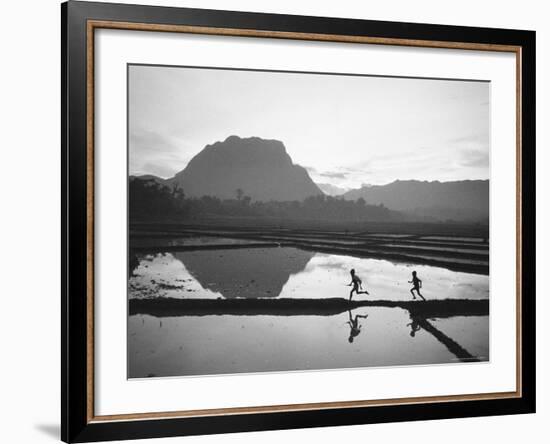 Boys Running Through Flooded Rice Paddy-John Dominis-Framed Photographic Print