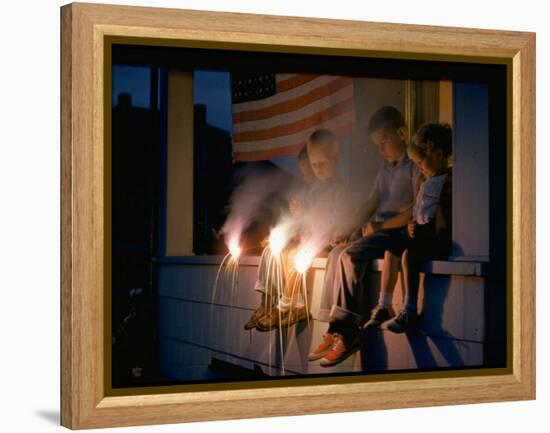 Boys Sitting on Porch Holding Sparklers, with US Flag in Back, During Independence Day Celebration-Nat Farbman-Framed Premier Image Canvas