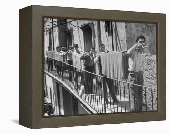 Boys Working in Pasta Factory Carry Rods of Pasta to Drying Rooms-Alfred Eisenstaedt-Framed Premier Image Canvas