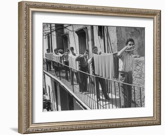 Boys Working in Pasta Factory Carry Rods of Pasta to Drying Rooms-Alfred Eisenstaedt-Framed Photographic Print