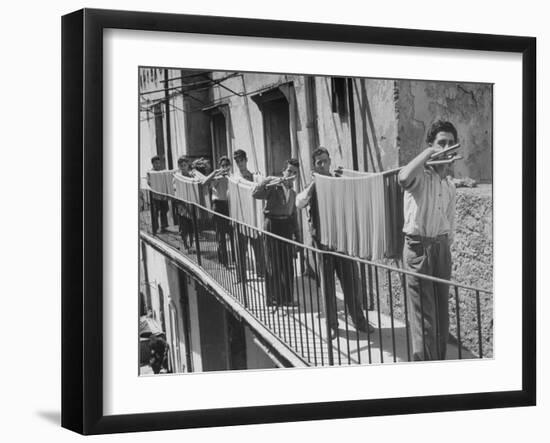 Boys Working in Pasta Factory Carry Rods of Pasta to Drying Rooms-Alfred Eisenstaedt-Framed Photographic Print