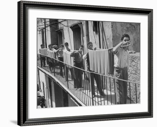 Boys Working in Pasta Factory Carry Rods of Pasta to Drying Rooms-Alfred Eisenstaedt-Framed Photographic Print