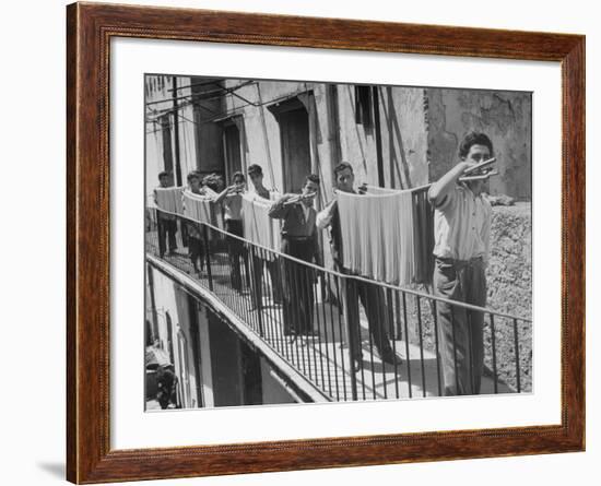 Boys Working in Pasta Factory Carry Rods of Pasta to Drying Rooms-Alfred Eisenstaedt-Framed Photographic Print