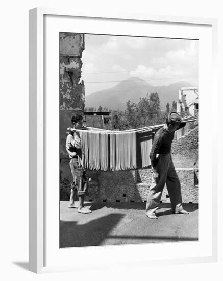 Boys Working in Pasta Factory Carry Rods of Pasta to Drying Rooms-Alfred Eisenstaedt-Framed Photographic Print