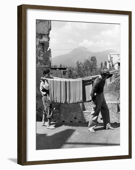 Boys Working in Pasta Factory Carry Rods of Pasta to Drying Rooms-Alfred Eisenstaedt-Framed Photographic Print