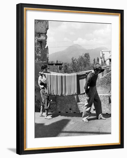 Boys Working in Pasta Factory Carry Rods of Pasta to Drying Rooms-Alfred Eisenstaedt-Framed Photographic Print