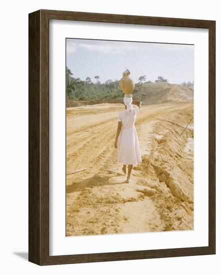 Brazilian Woman Walking Down a Sandy Road Carrying a Large Jar on Her Head-Dmitri Kessel-Framed Photographic Print