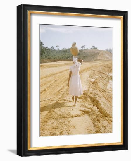 Brazilian Woman Walking Down a Sandy Road Carrying a Large Jar on Her Head-Dmitri Kessel-Framed Photographic Print