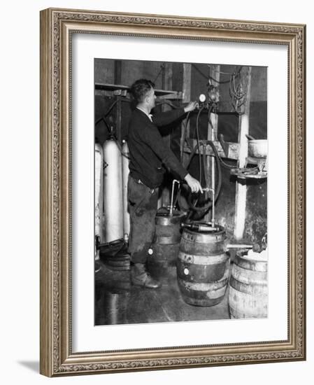 'Brewmeister' Fills Kegs at a Bootleg Brewery During Prohibition, 1933-null-Framed Photo