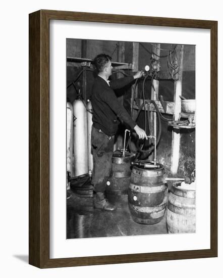 'Brewmeister' Fills Kegs at a Bootleg Brewery During Prohibition, 1933-null-Framed Photo