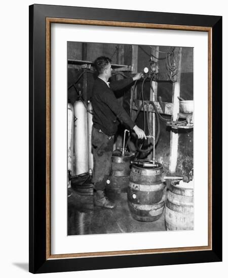 'Brewmeister' Fills Kegs at a Bootleg Brewery During Prohibition, 1933-null-Framed Photo