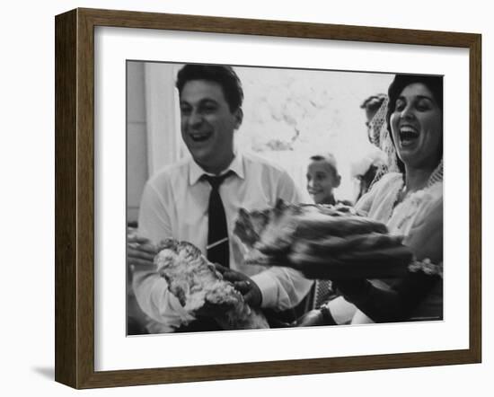 Bride and Groom Breaking Bread During Wedding-Paul Schutzer-Framed Photographic Print