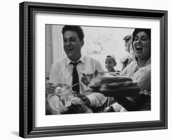 Bride and Groom Breaking Bread During Wedding-Paul Schutzer-Framed Photographic Print