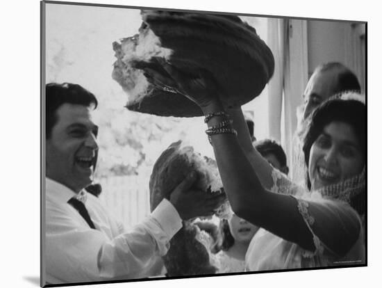 Bride and Groom Breaking Bread During Wedding-Paul Schutzer-Mounted Photographic Print