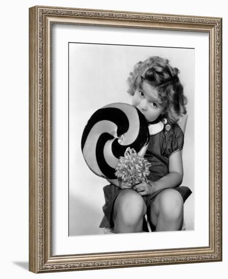 Bright Eyes, Shirley Temple Eating a Big Lollipop, 1934-null-Framed Photo
