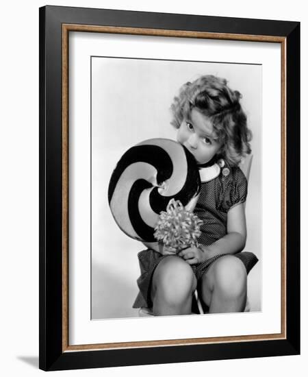 Bright Eyes, Shirley Temple Eating a Big Lollipop, 1934-null-Framed Photo