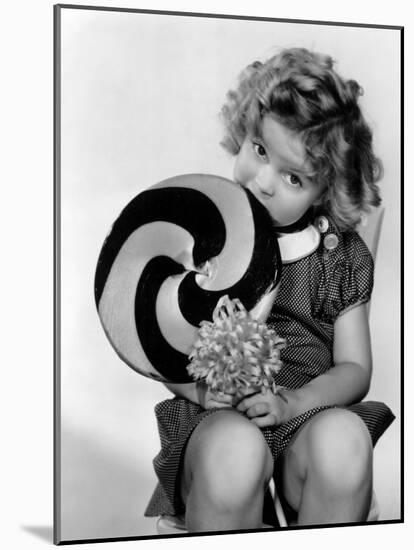 Bright Eyes, Shirley Temple Eating a Big Lollipop, 1934-null-Mounted Photo