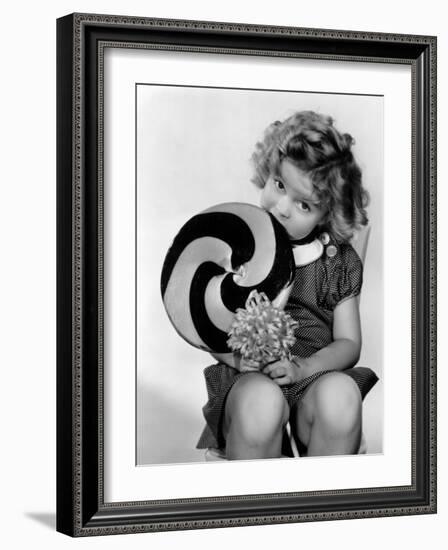 Bright Eyes, Shirley Temple Eating a Big Lollipop, 1934-null-Framed Photo