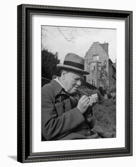 Britain's Prime Minister Winston Churchill Lighting a Cigar-null-Framed Photographic Print