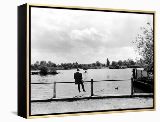 British Actor Alec Guinness Sitting Alone by Lake in a Park-Cornell Capa-Framed Premier Image Canvas