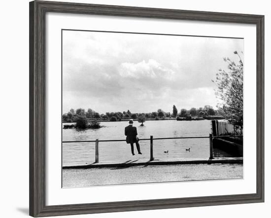 British Actor Alec Guinness Sitting Alone by Lake in a Park-Cornell Capa-Framed Premium Photographic Print