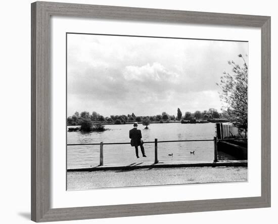 British Actor Alec Guinness Sitting Alone by Lake in a Park-Cornell Capa-Framed Premium Photographic Print