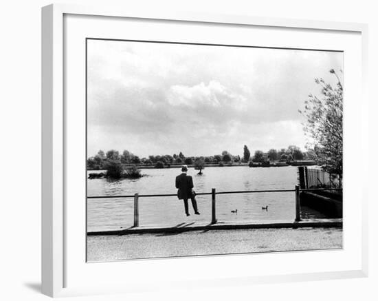 British Actor Alec Guinness Sitting Alone by Lake in a Park-Cornell Capa-Framed Premium Photographic Print