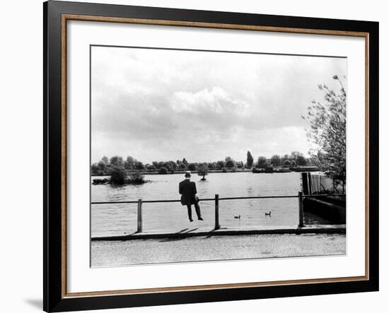 British Actor Alec Guinness Sitting Alone by Lake in a Park-Cornell Capa-Framed Premium Photographic Print