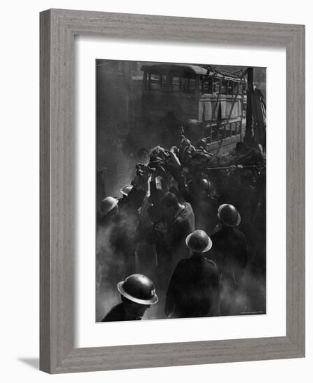 British Female Casualty of German Robot Bombing Being Lifted on Stretcher by Rescue Squad-George Rodger-Framed Photographic Print