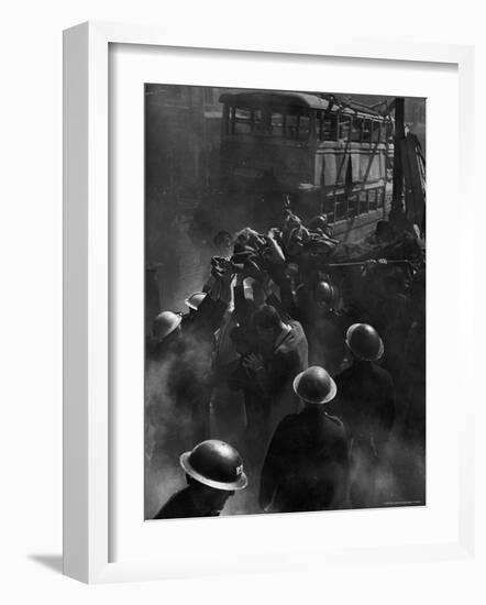 British Female Casualty of German Robot Bombing Being Lifted on Stretcher by Rescue Squad-George Rodger-Framed Photographic Print