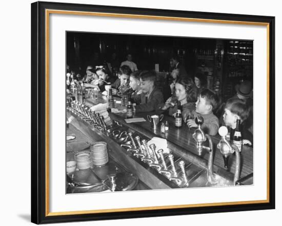 British Refugee Children Eating Ice Cream and Drinking Ginger Ale at a Soda Fountain-John Phillips-Framed Premium Photographic Print