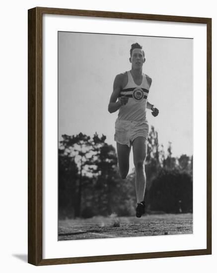 British Track Runner Roger Bannister Running, the First Person to Run a Mile in under Four Minutes-Cornell Capa-Framed Premium Photographic Print