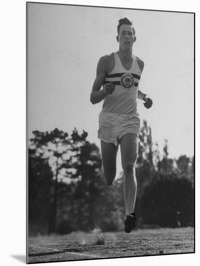 British Track Runner Roger Bannister Running, the First Person to Run a Mile in under Four Minutes-Cornell Capa-Mounted Premium Photographic Print