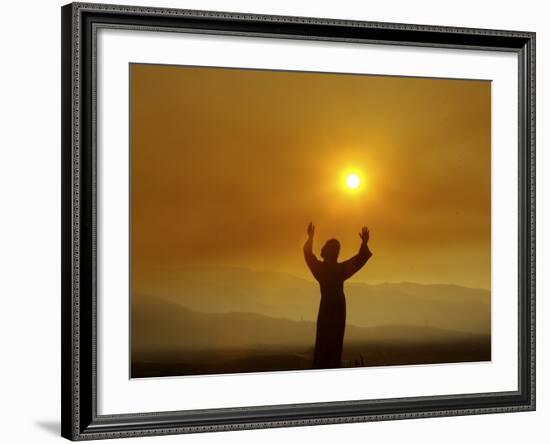 Bronze Statue of Jesus Stands at Cemetery Overlooking a Wildfire Burning in Anaheim Hills Area-null-Framed Photographic Print