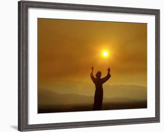 Bronze Statue of Jesus Stands at Cemetery Overlooking a Wildfire Burning in Anaheim Hills Area-null-Framed Photographic Print