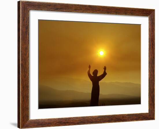 Bronze Statue of Jesus Stands at Cemetery Overlooking a Wildfire Burning in Anaheim Hills Area-null-Framed Photographic Print