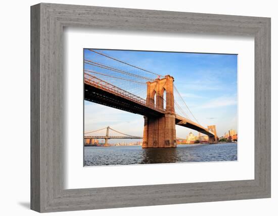 Brooklyn Bridge over East River Viewed from New York City Lower Manhattan Waterfront at Sunset.-Songquan Deng-Framed Photographic Print